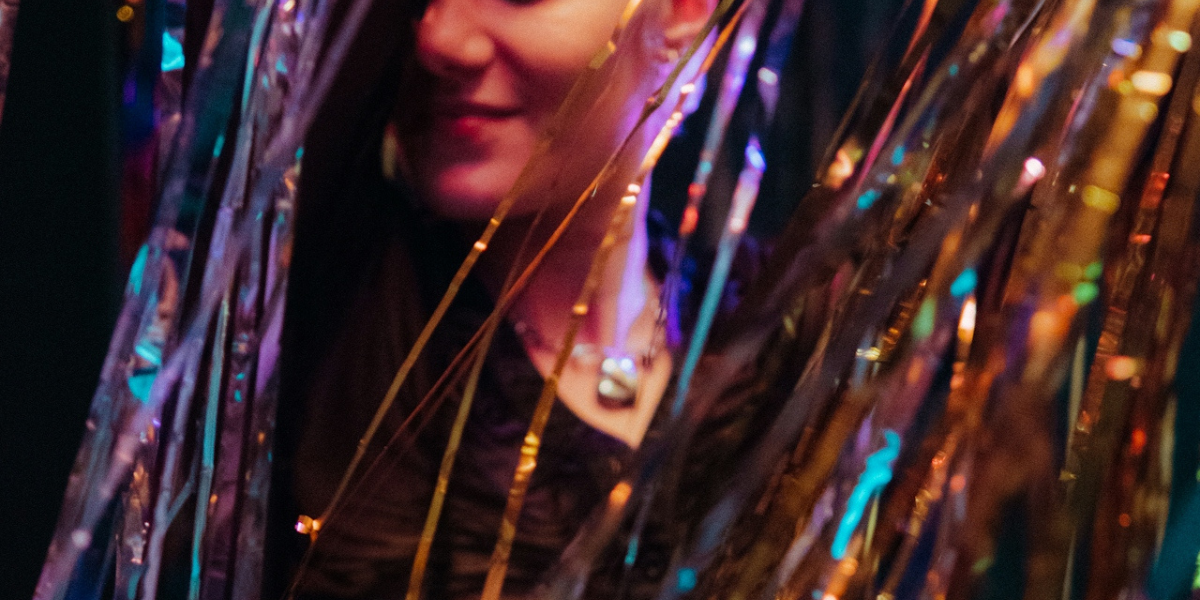 a person dancing in rainbow streamers