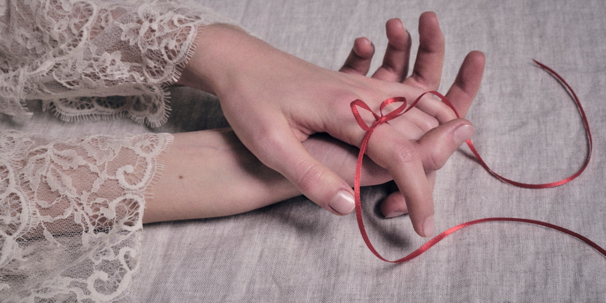 a woman's hand and some ribbon
