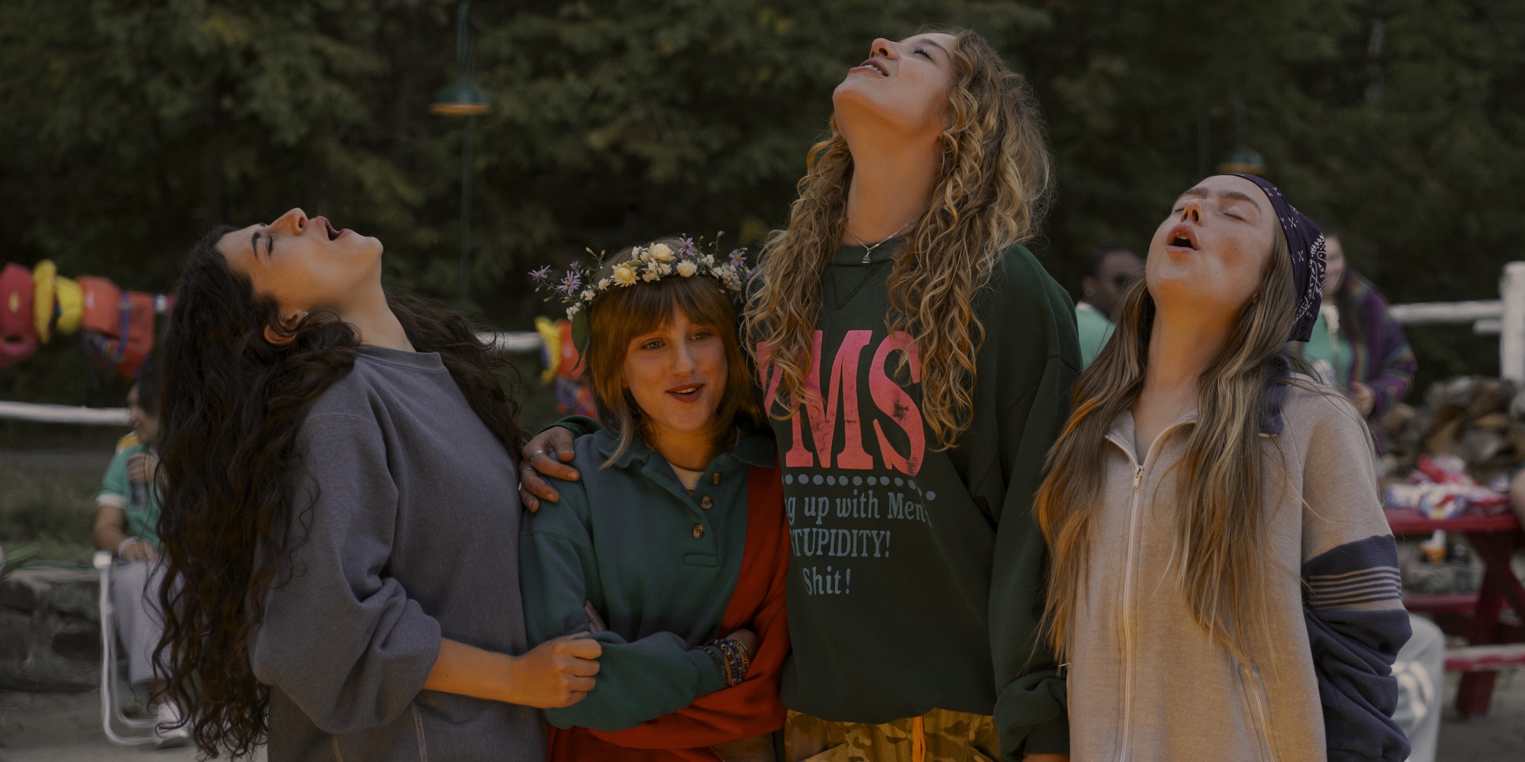 Press image from Sterling Point: Annie, Maple, Oona, and Ramona stand around a fire and howl at the moon