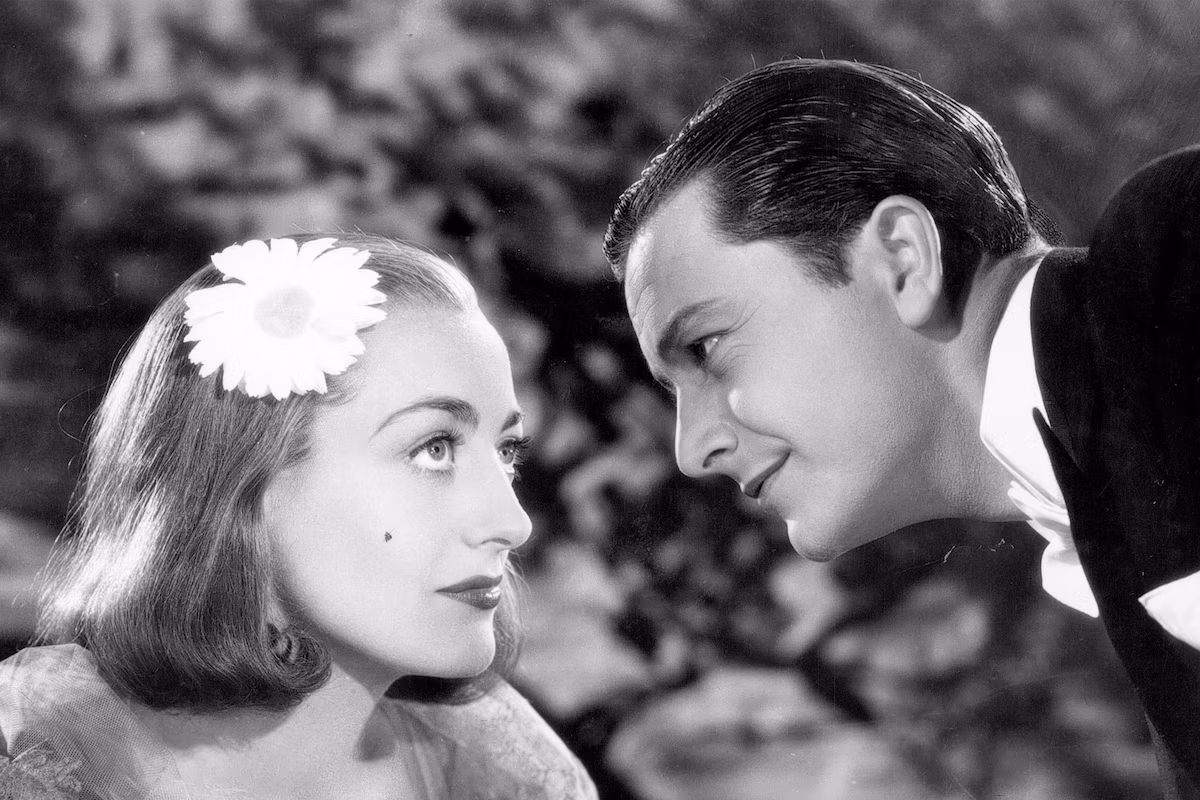 a woman and man looking at each other in The Bride Wore Red