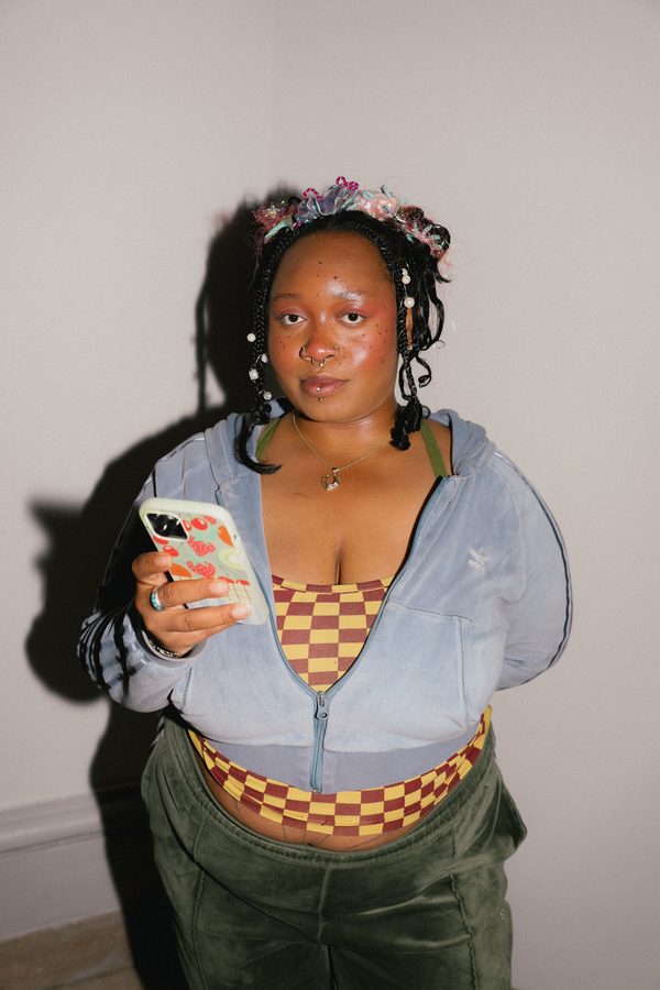 Cheyenne, a model for Jasmine Knits, waits backstage in fresh hair and makeup for the runway walkthrough at the Brooklyn Museum.