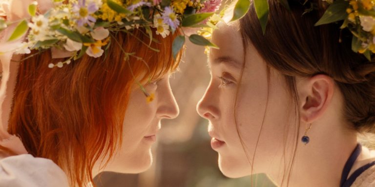 From the show Monster: The Lizzie Borden Story, Bridget and Lizzie wear flower crowns and look into each other's eyes while their noses are barely an inch apart, as if they might kiss at any moment. Photo courtesy of Netflix.