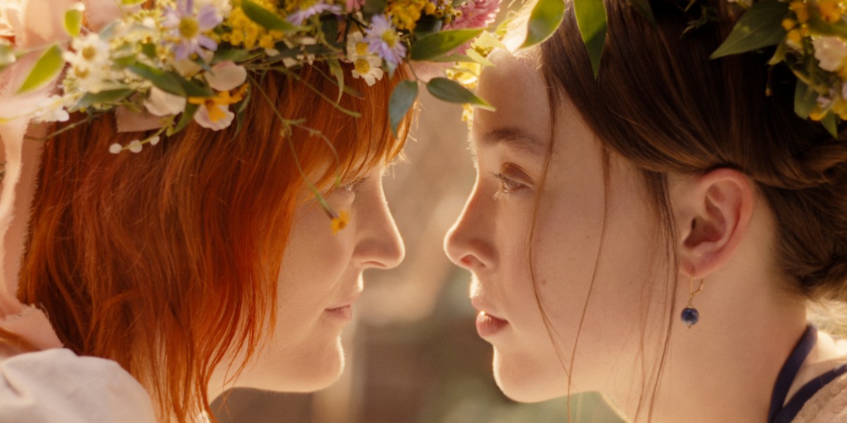 From the show Monster: The Lizzie Borden Story, Bridget and Lizzie wear flower crowns and look into each other's eyes while their noses are barely an inch apart, as if they might kiss at any moment. Photo courtesy of Netflix.