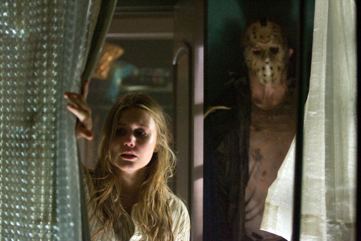 Friday the 13th (2009), a woman pulls back a curtain and Jason is standing behind her