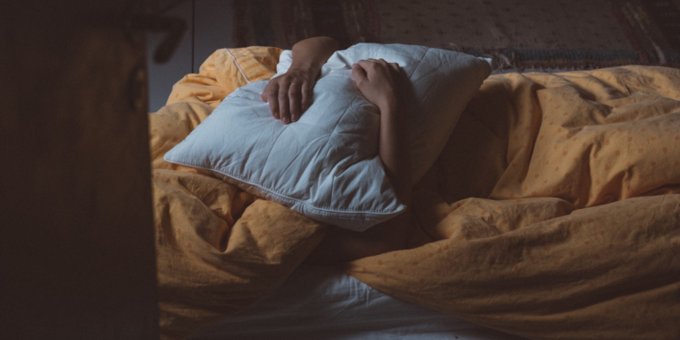 a person clutching a pillow