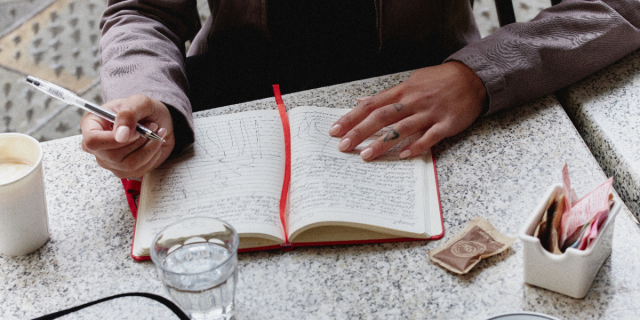 a person writing in a notebook