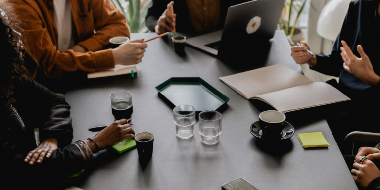 a group of people around a desk
